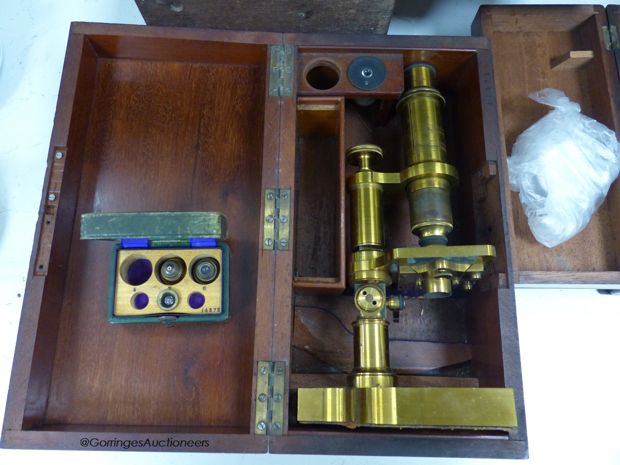 Three mahogany cased travelling microscopes and cased lenses